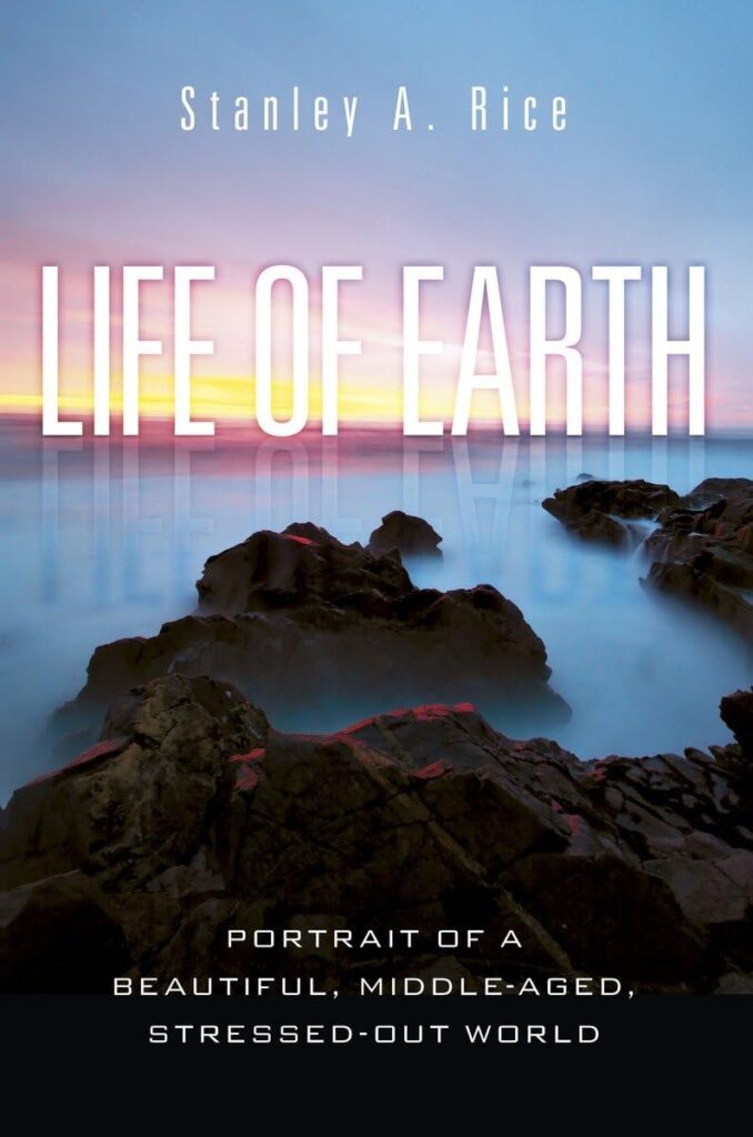Cover of the book "Life of Earth" by Stanley Rice which is a photo of rock formations peaking out of a thick fog with a beautiful sunrise on the horizon.
