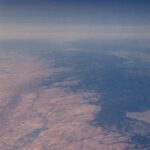 An aerial view of the Sierra Nevada rain shadow in California. The rain and snow comes from the west (right, in this view), and by the time the wind gets to the east side (left), it contains little moisture.