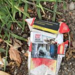 A graphic cigarette pack thrown on the ground in Hoenheim, north of Strasbourg, France. Most cigarettes come from Germany, where they are cheaper because they are taxed less than in France. Germany is just over the bridge from Strasbourg. There are a lot of smokers in France, who seem undeterred by the images, and who also disproportionately throw litter on the ground. Was tut man? The sad woman on this pack implies that smoking causes disabilities.