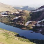 Alpine tundra lake, Beartooth Mountains, Montana. The summer is too short and all the plants must overwinter under the snow, so there are no tall trees in this zone.