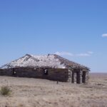 On the high plains (here, New Mexico), the Dust Bowl created desert conditions and many people abandoned their houses and moved elsewhere. This house probably dates from after the Dust Bowl, also called the dirty thirties because of the dust from soil erosion.