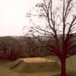 Etowah Mound near Cartersville, Georgia. Reconstructed by archaeologists, this mound is a remnant of the Mississippian civilization of Native Americans which flourished and collapsed before the first Europeans came. The civilization was also called Cahokian because its capital appeared to be Cahokia, now in southern Illinois. The mound had a wooden building on top used for religious rites.