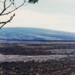 Two kinds of lava visible from the Saddle Road across the big island of Hawaii. A flow of smooth lava (pahoehoe) across the sharp a'a lava. A'a lava has more gas bubbles which create a rough surface as they escape while the lava is cooling.